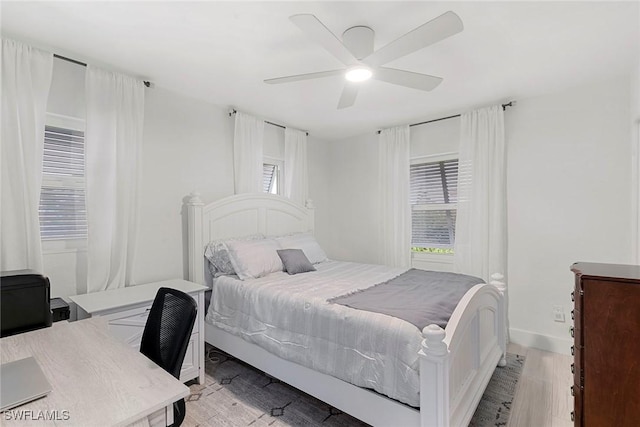 bedroom with light wood-type flooring and ceiling fan