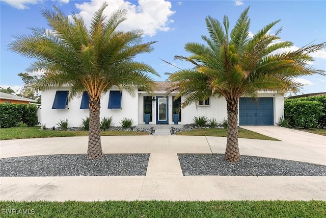 obstructed view of property with a garage