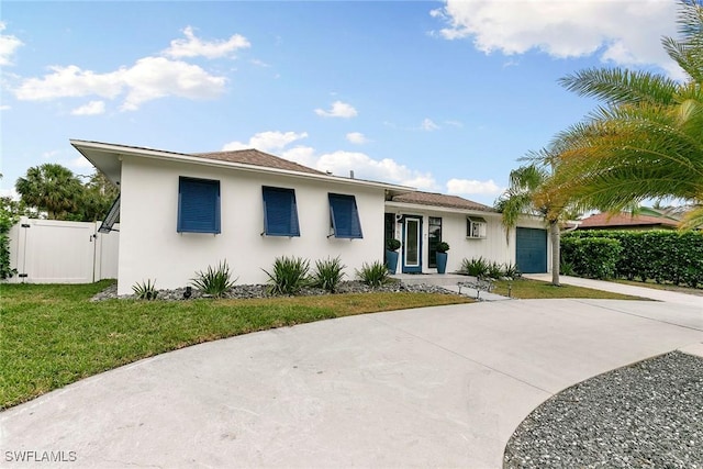 view of front of home featuring a garage and a front lawn