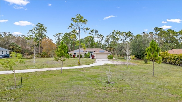 view of front of property with a garage and a front lawn