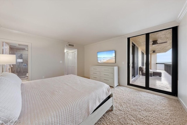 carpeted bedroom with floor to ceiling windows, access to exterior, ornamental molding, and ensuite bath