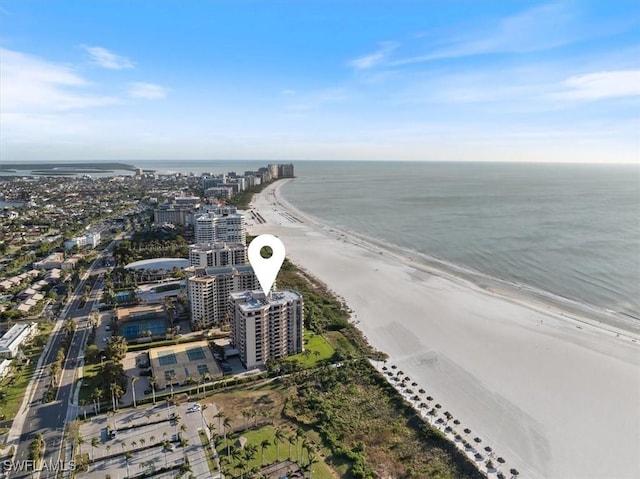 birds eye view of property with a water view and a view of the beach