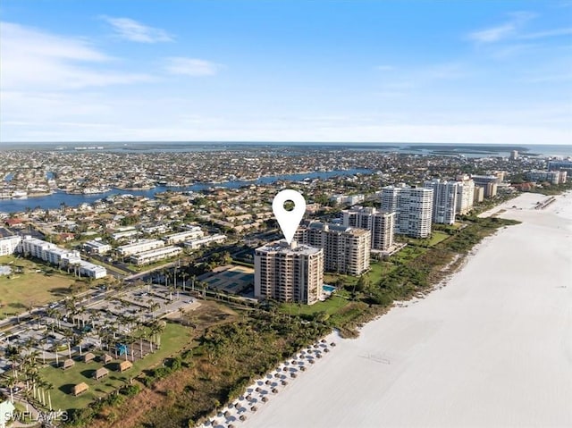 drone / aerial view featuring a water view and a beach view