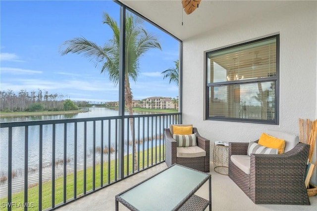 balcony with a water view and ceiling fan