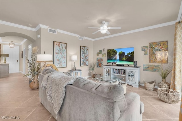 living room with light tile patterned flooring, ceiling fan, and ornamental molding