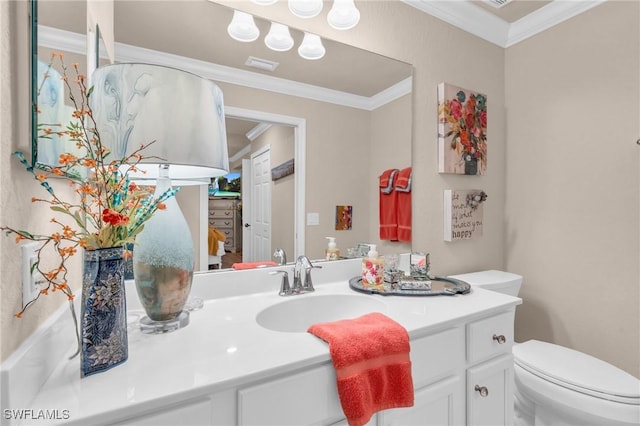 bathroom featuring vanity, ornamental molding, and toilet