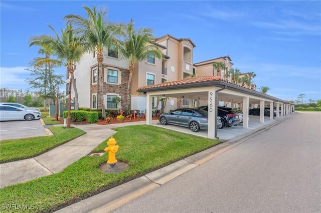 exterior space featuring a yard and a carport