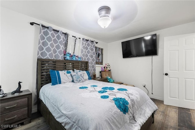 bedroom featuring ceiling fan and dark hardwood / wood-style flooring