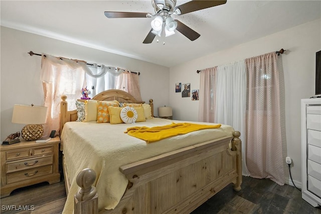 bedroom with ceiling fan and dark wood-type flooring