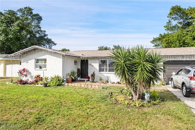 ranch-style home with a front lawn and a garage