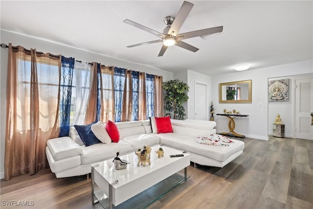 living room with ceiling fan and hardwood / wood-style flooring