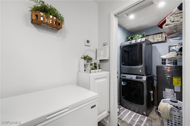 clothes washing area featuring stacked washing maching and dryer and water heater