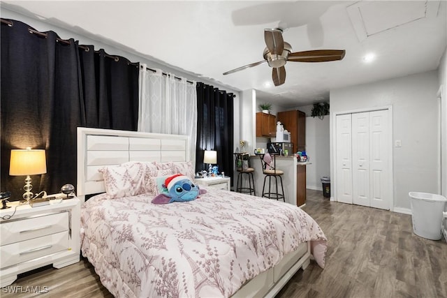 bedroom with a closet, hardwood / wood-style flooring, and ceiling fan