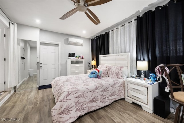 bedroom featuring ceiling fan, wood-type flooring, and a wall unit AC