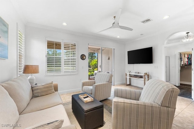 living room featuring ceiling fan, ornamental molding, and light tile patterned floors