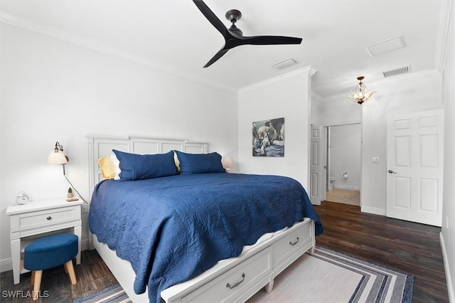 bedroom featuring ceiling fan, ornamental molding, and dark hardwood / wood-style flooring