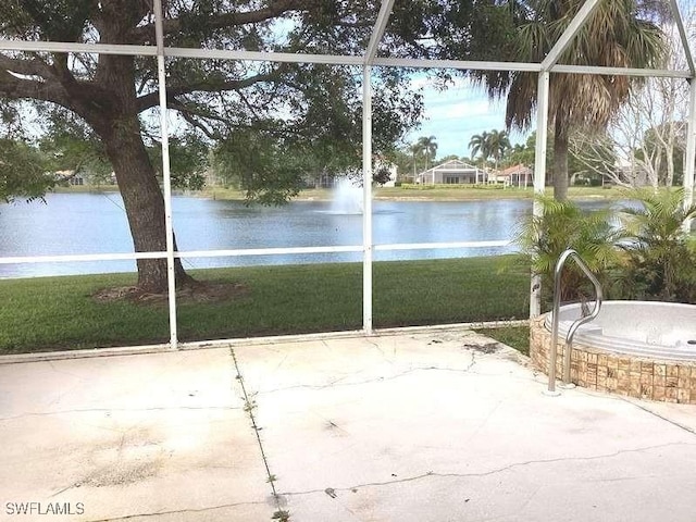 unfurnished sunroom with a water view