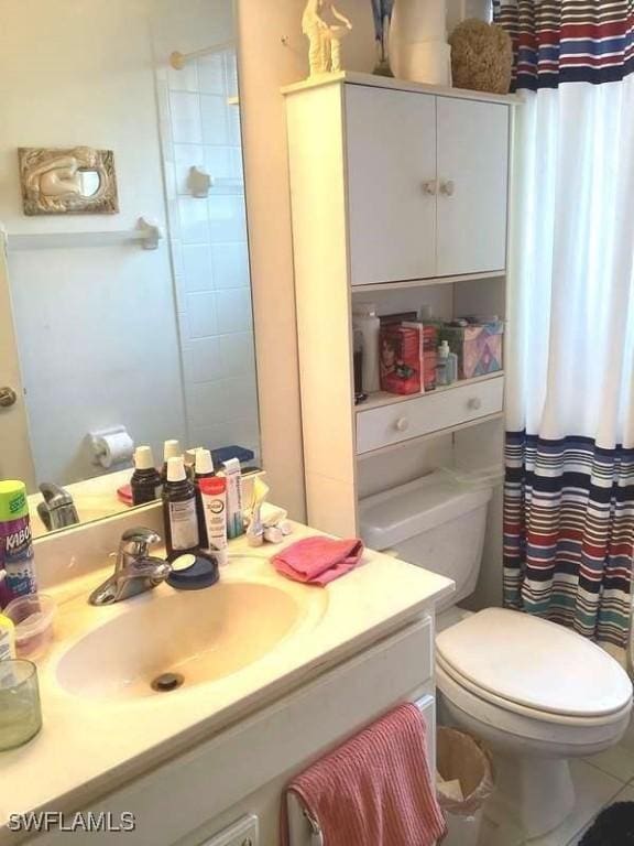 bathroom with vanity, toilet, tile patterned flooring, and a shower with shower curtain