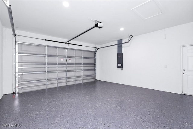 garage with a garage door opener and electric panel