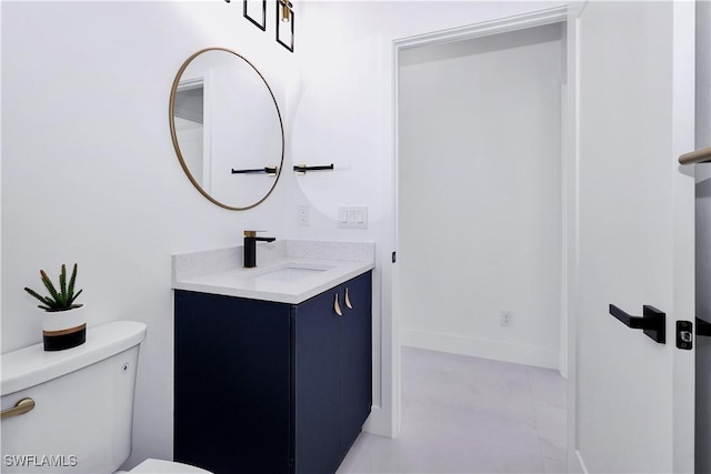 bathroom featuring toilet and vanity