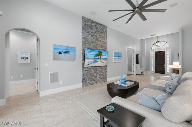 living room featuring a towering ceiling and ceiling fan