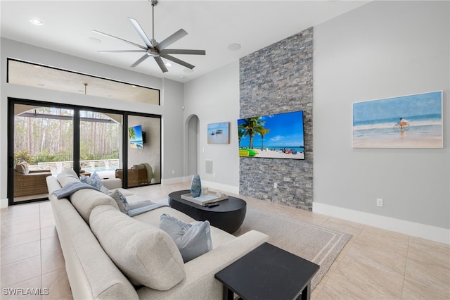 tiled living room featuring ceiling fan