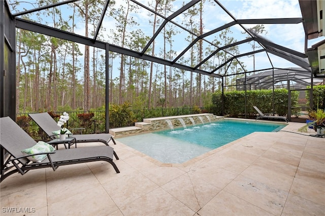 view of swimming pool featuring a patio, pool water feature, and glass enclosure