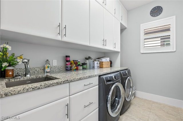 laundry area with cabinets, sink, and washing machine and clothes dryer