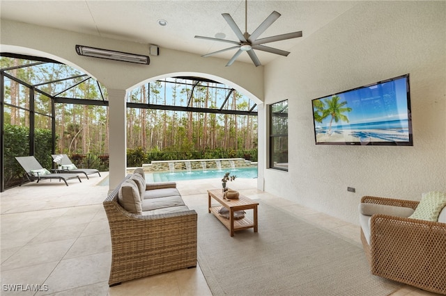 view of patio / terrace featuring a lanai, an outdoor hangout area, pool water feature, and ceiling fan