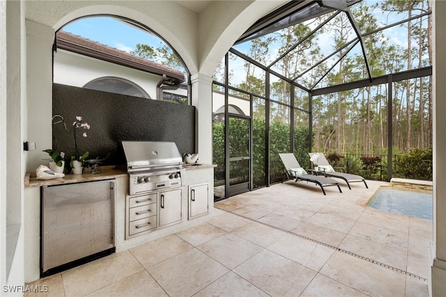 view of patio with grilling area, a lanai, exterior kitchen, and a swimming pool