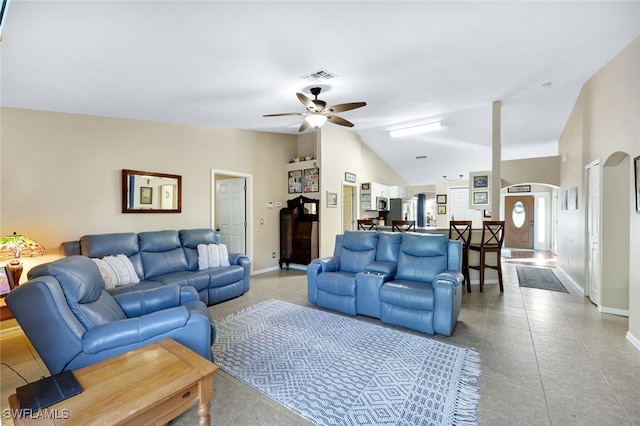 living room with ceiling fan and vaulted ceiling