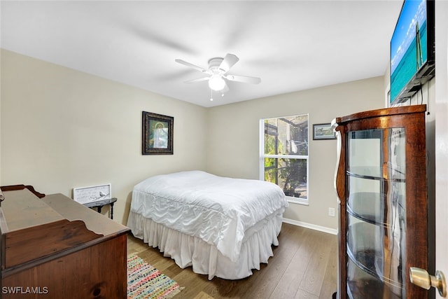 bedroom with ceiling fan and wood-type flooring