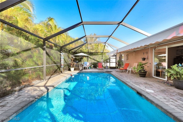 view of pool featuring a patio and glass enclosure