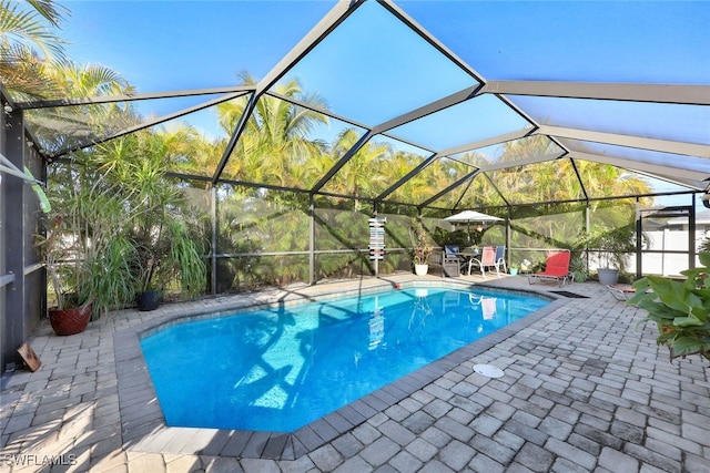 view of swimming pool featuring a lanai and a patio area