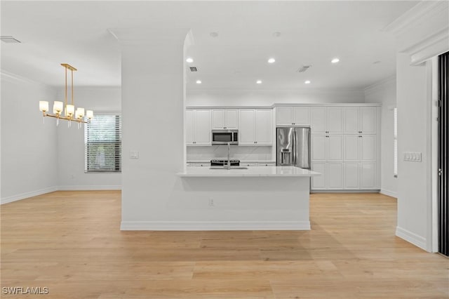 kitchen with stainless steel appliances, light wood finished floors, light countertops, and crown molding