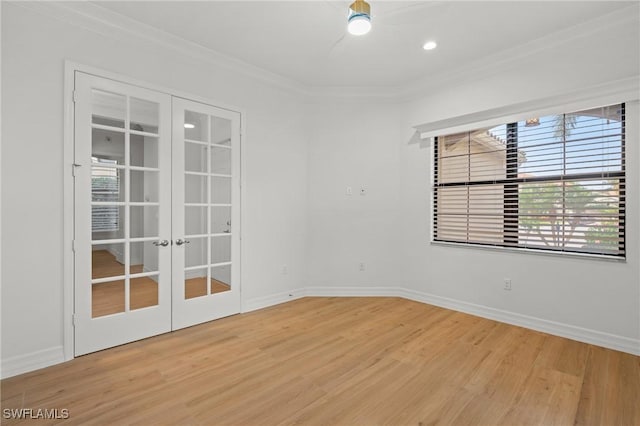 spare room with ornamental molding, french doors, wood finished floors, and baseboards