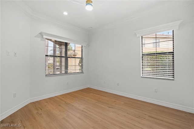 empty room with light hardwood / wood-style flooring and ornamental molding