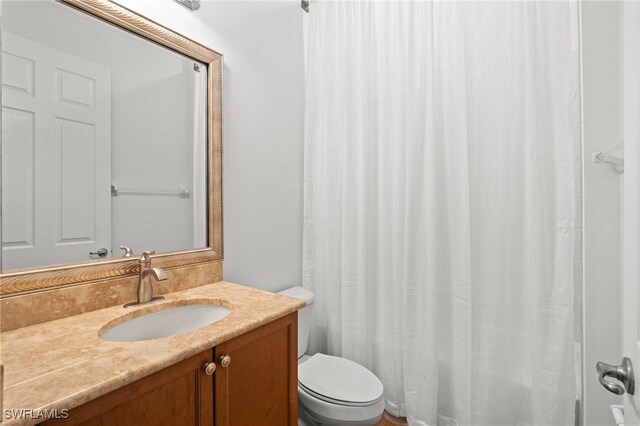 bathroom with toilet and vanity