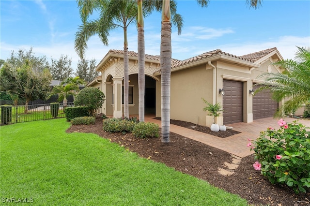 rear view of property featuring a garage and a yard