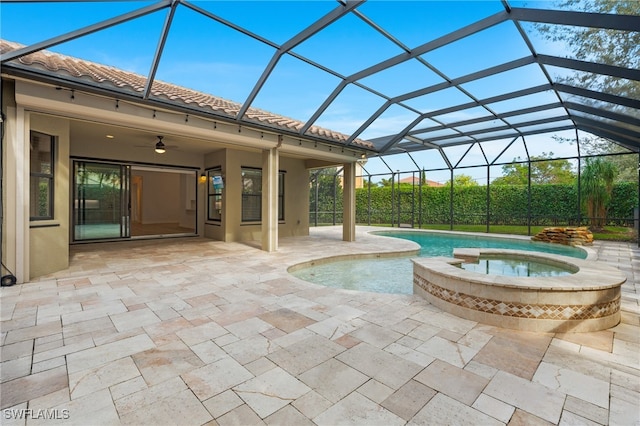 view of swimming pool with a patio area, a lanai, and a pool with connected hot tub