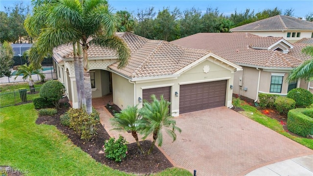 view of front of home featuring a garage, stucco siding, fence, and a tiled roof