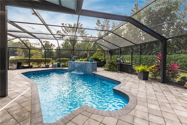 view of swimming pool with pool water feature, a lanai, and a patio area