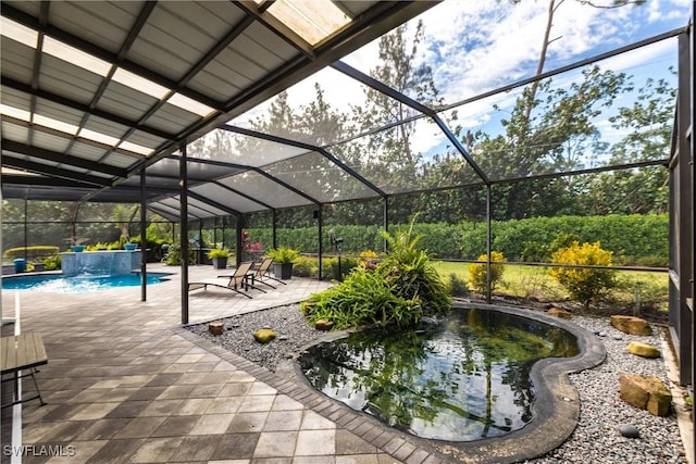 view of patio / terrace with pool water feature and a lanai