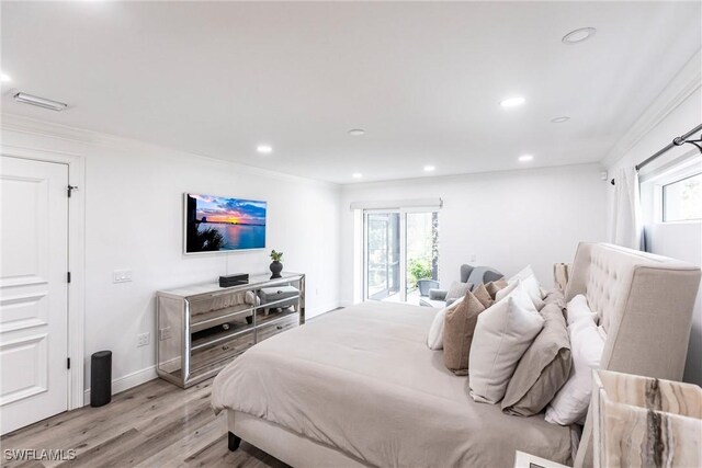 bedroom with ornamental molding and light wood-type flooring