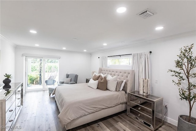 bedroom featuring ornamental molding, access to exterior, multiple windows, and light hardwood / wood-style flooring