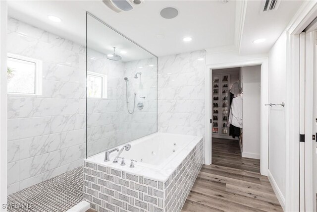 bathroom with ceiling fan, shower with separate bathtub, and hardwood / wood-style floors