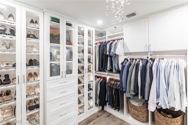 walk in closet featuring light hardwood / wood-style floors