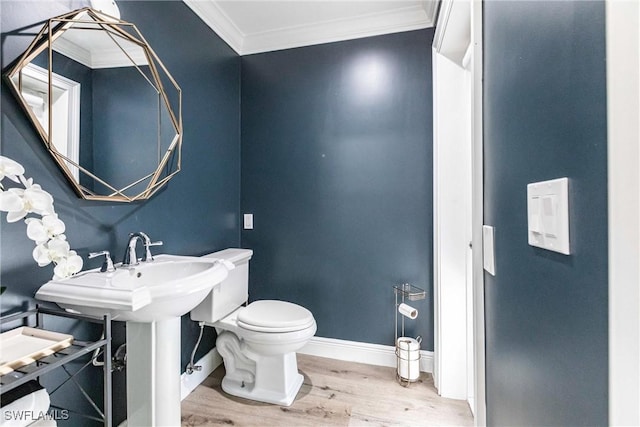 bathroom featuring crown molding, wood-type flooring, and toilet