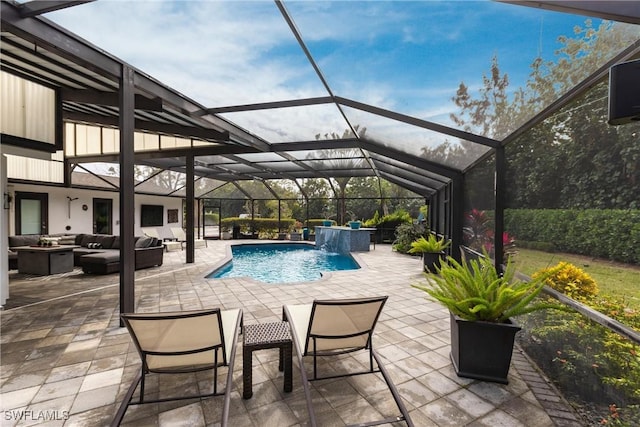 view of pool with a patio, outdoor lounge area, pool water feature, and glass enclosure