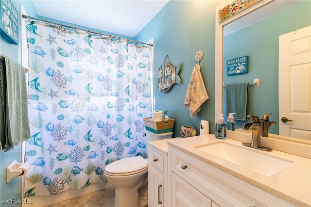 bathroom with toilet, vanity, and curtained shower